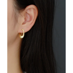 Minimalist S925 silver irregular golden hoop earrings on model with sleek finish