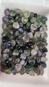 Close-up of polished 15mm heart-shaped natural crystals in various colorful fluorite stones