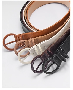 Close-up of five colorful slim PU leather belts with round buckles for women jeans