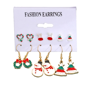 Detail of Christmas earring set featuring Santa, snowflakes, and festive reindeer charms