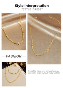 Close-up of gold-plated stainless steel clover necklace and bracelet with pavé crystal detail