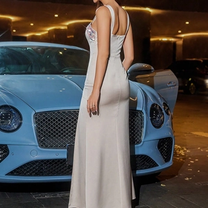 Detail of silver silk evening gown with sequin embellishments and open back design