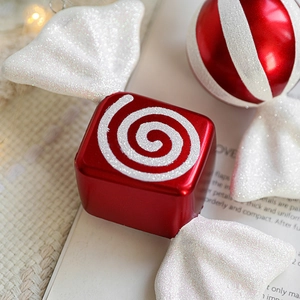 Red and white striped Christmas candy ornaments with glitter accents for tree decoration