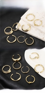 Detailed close-up of polished gold stainless steel rings with various textures and knots