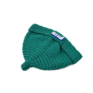 Close-up of knit texture and blue PLIG label on dark green beanie for kids