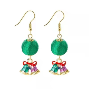 Detail of Christmas earrings featuring green woven balls and colorful enamel holiday bells
