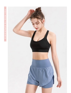 Detail of high waist blue double-layer sports shorts with black sports bra set