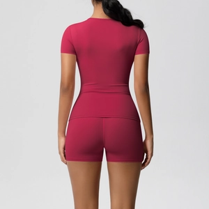 Detail of slim-fit athletic two-piece set with back view of pink yoga t-shirt and shorts