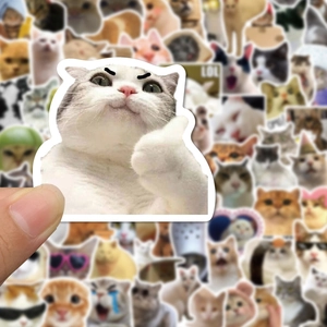 Close-up of a thumbs-up cat meme sticker among a variety of funny kitten decals