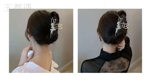 Detail view of a metallic butterfly hair claw clip with rhinestones on dark hair