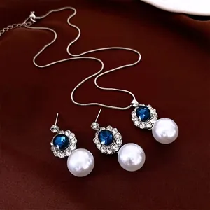French luxury jewelry set with blue oval gemstones and pearls on brown velvet