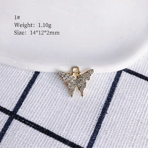 Detail of butterfly pendant with gold plating and crystals, measuring 14x12x2mm