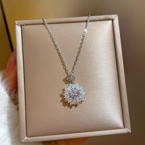 Macro view of halo sparkling zircon pendant necklace resting in a premium jewelry box