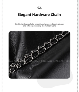 Detail of silver metal chain interwoven with black leather strap on a textured tote bag