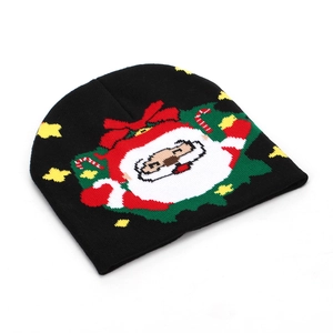 Knitted Christmas beanie with Santa Claus motif and festive red green holiday patterns