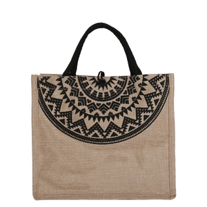 Ethnic jute tote bag with geometric print and rope handles on a white background