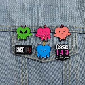 Detailed close-up of six Case 143 enamel pins styled on a blue denim jacket pocket