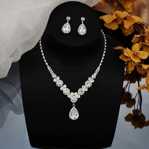 Detailed view of elegant silver-tone bridal jewelry set with V-shaped necklace and drop earrings