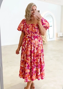 Close-up of summer floral midi dress with puff sleeves and elastic pleated bodice detail