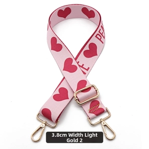 Detail showing 3.8cm pink wide bag strap with red heart pattern and light gold hooks