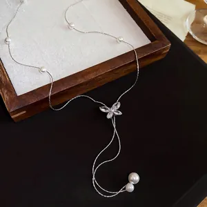 Elegant silver butterfly Y-shaped necklace with white pearls and sparkling marquise crystals