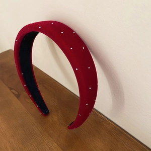 Detail of red velvet headband with white micro beads and non-slip black inner lining