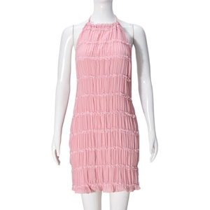 Detailed view of the fine pleated fabric and pink bodycon texture on the halter dress
