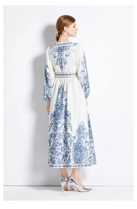 Detail of V-neck long sleeve dress with blue floral paisley pattern and high waist tie