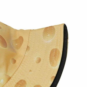 Close-up of yellow cheese texture fisherman hat with black edge piping and fine stitching