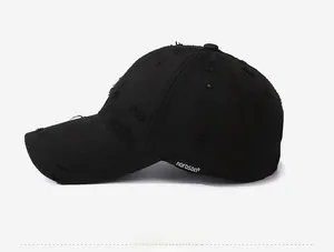 Detail view of washed cotton baseball cap featuring vintage distressed edges and side label