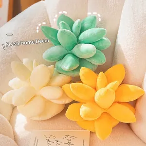 Plush succulent plant pillows in green, white and yellow on a cozy white armchair