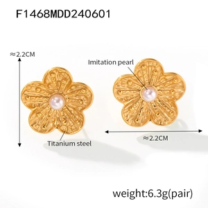 Detail showing 2.2cm golden petal earrings with imitation pearl in titanium steel