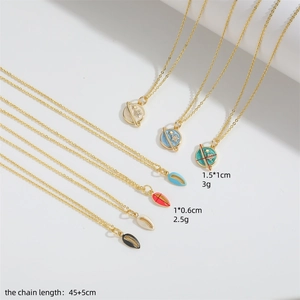 Gold star and planet pendant necklaces in blue, red, and black on a white background