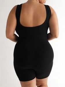 Back view of a black athletic one-piece yoga jumpsuit showing fit and silhouette