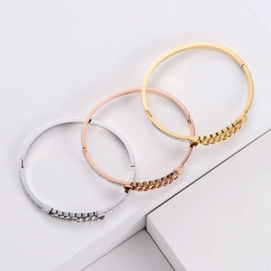 Three polished titanium steel bracelets in gold, silver, and rose gold with zircon inlay