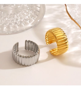 Macro detail of vertical ribbed texture on minimalist gold and silver open rings