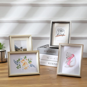 Nordic minimalist rectangle photo frames in gold and silver set on a wooden table