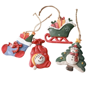 Set of 4 resin Christmas tree ornaments including stockings and sled with Let It Snow text