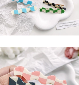 Detail of wavy checkerboard hair clips in candy colors showing glossy resin texture