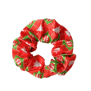 Christmas hair scrunchie with festive red and green patterns and white tree prints