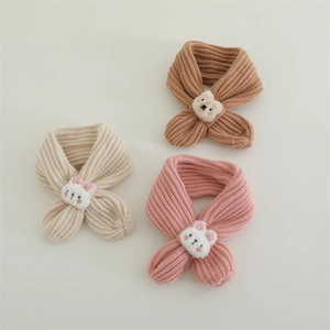 Detailed view of kids knitted cross scarves in cream, brown, and pink with cute animal charms