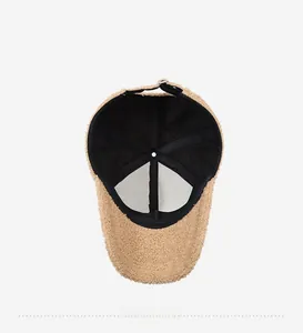 Interior view of khaki teddy fleece baseball cap with black lining and adjustable metal buckle