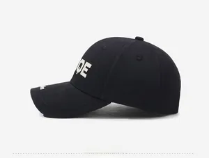 Close-up of high-quality white OE letter embroidery on black cotton twill baseball cap