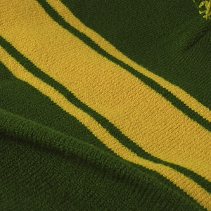 Green and yellow striped knit beanie with ear protection and pompom for outdoor warmth