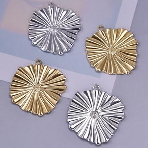 Macro shot of 4 irregular 304 stainless steel pendants in gold and silver for DIY jewelry