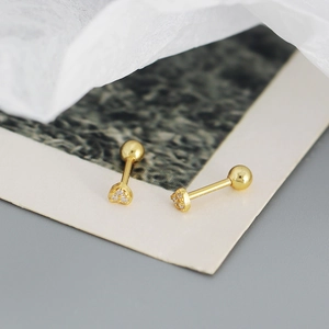 Detailed shot of gold heart stud earrings with sparkling clear cubic zirconia stones