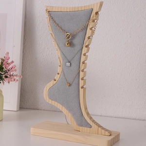 Bamboo and wood necklace display stand with creative foot shape and gray velvet backing
