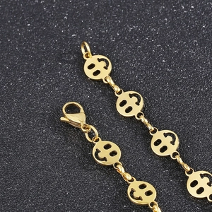 Macro shot of gold titanium steel hollow smile face pendant chain with lobster clasp detail