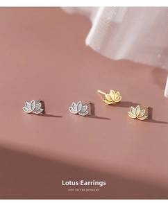 Macro shot of S999 sterling silver lotus flower stud earrings in silver and gold finishes