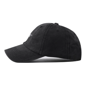 Side view of black washed cotton baseball cap with white letter embroidery details